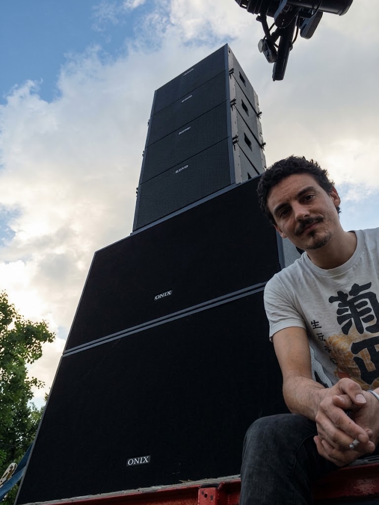 Dominique on-site with a stacked outdoor PA speaker system